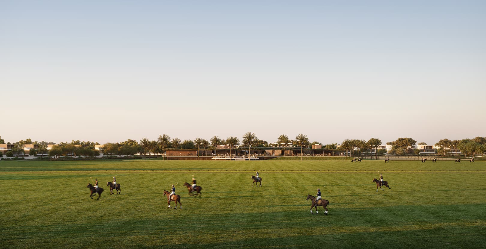 Selvara 4 community polo fields with riders at sunset