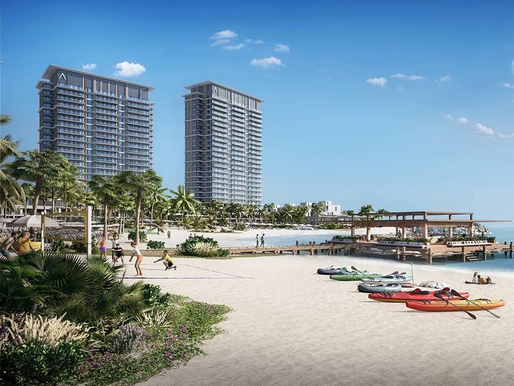 Beach and residential towers with kayaks on the sand; official developer rendering