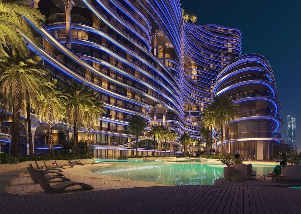 Binghatti Aquarise: Illuminated building and artificial-beach leisure area; official developer rendering