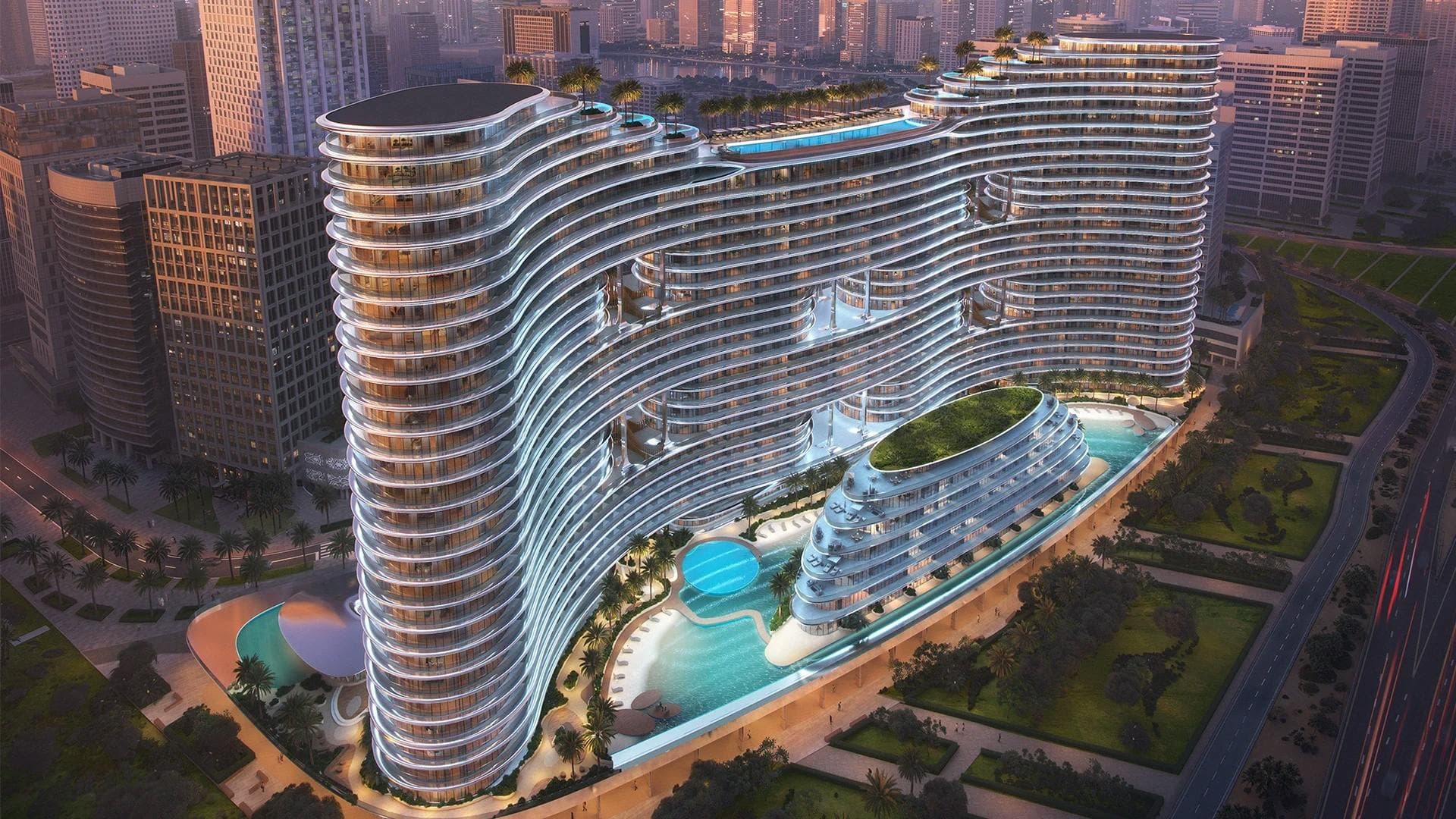 Binghatti Aquarise: Elevated view of Aquarise's curved facade and pool; official developer rendering