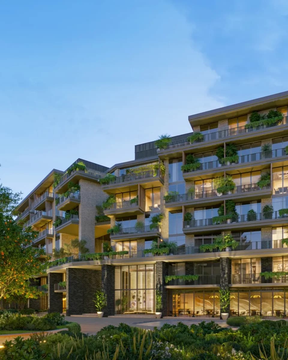 Arancia Yards: Residential facade with planted balconies at dusk; official developer rendering