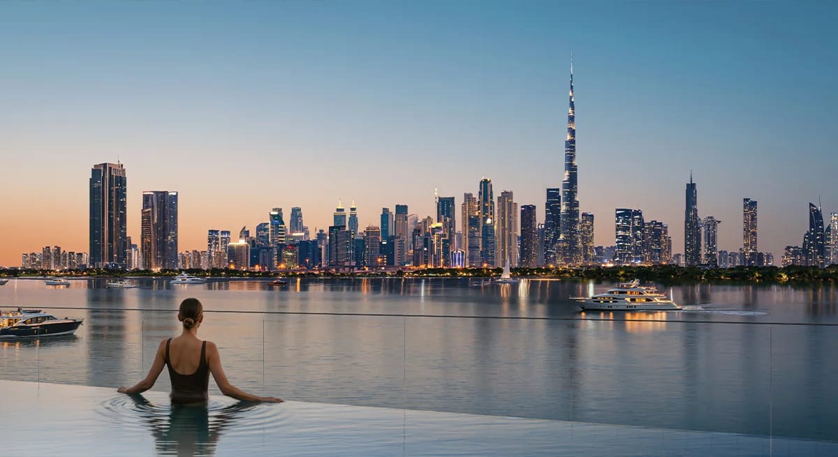 Creek Bay: pool-level view towards downtown dubai at dusk (developer rendering)