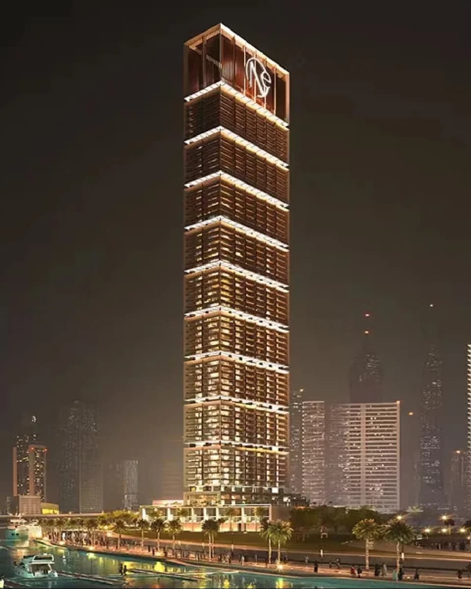 ONE by Binghatti: illuminated residential tower at night — rendering