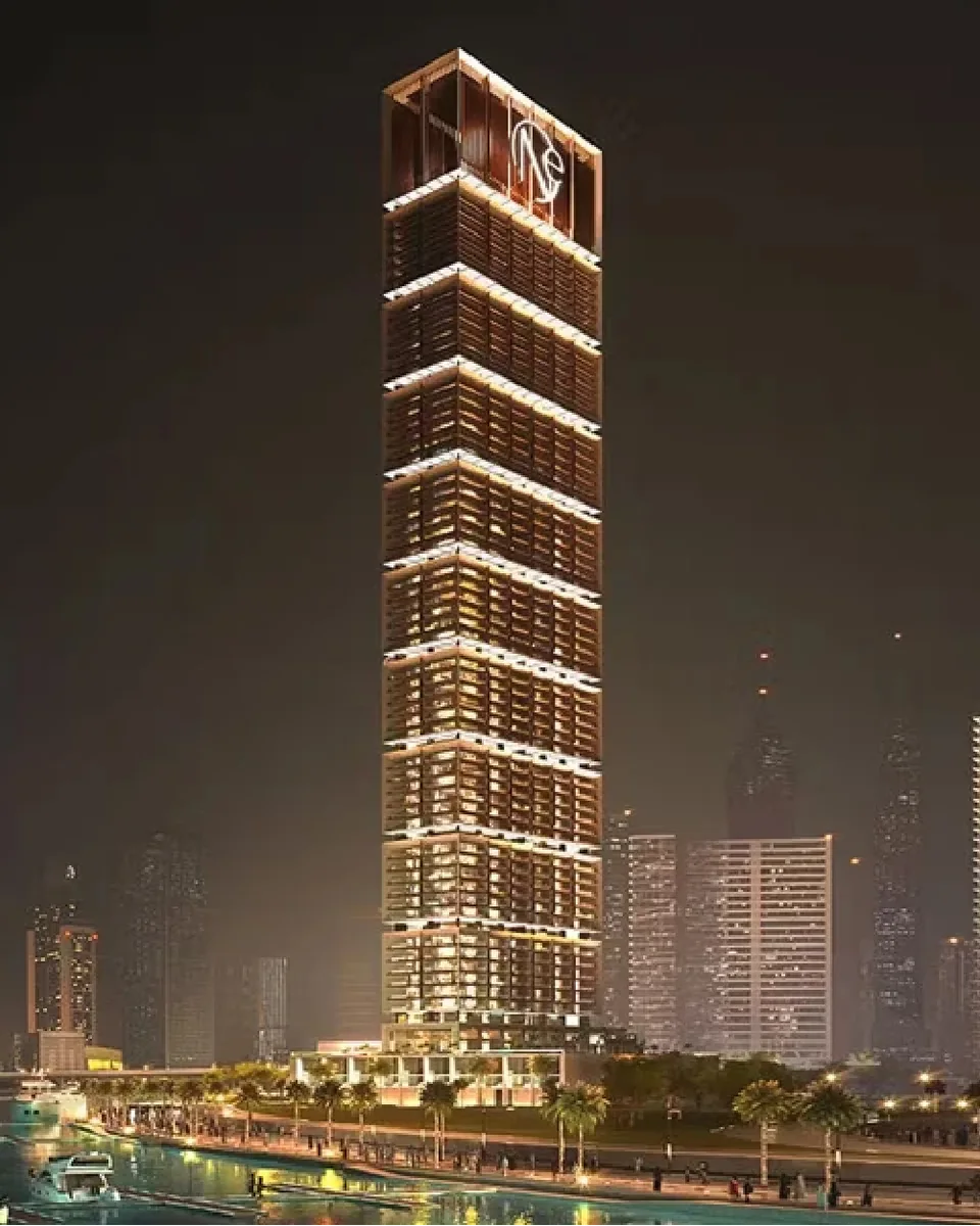 ONE by Binghatti: illuminated residential tower at night — rendering