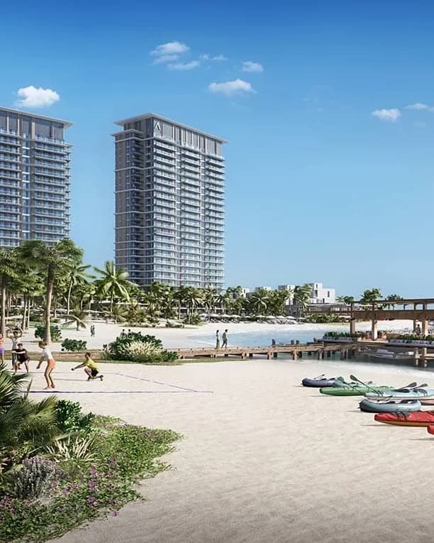 Beach and residential towers with kayaks on the sand; official developer rendering