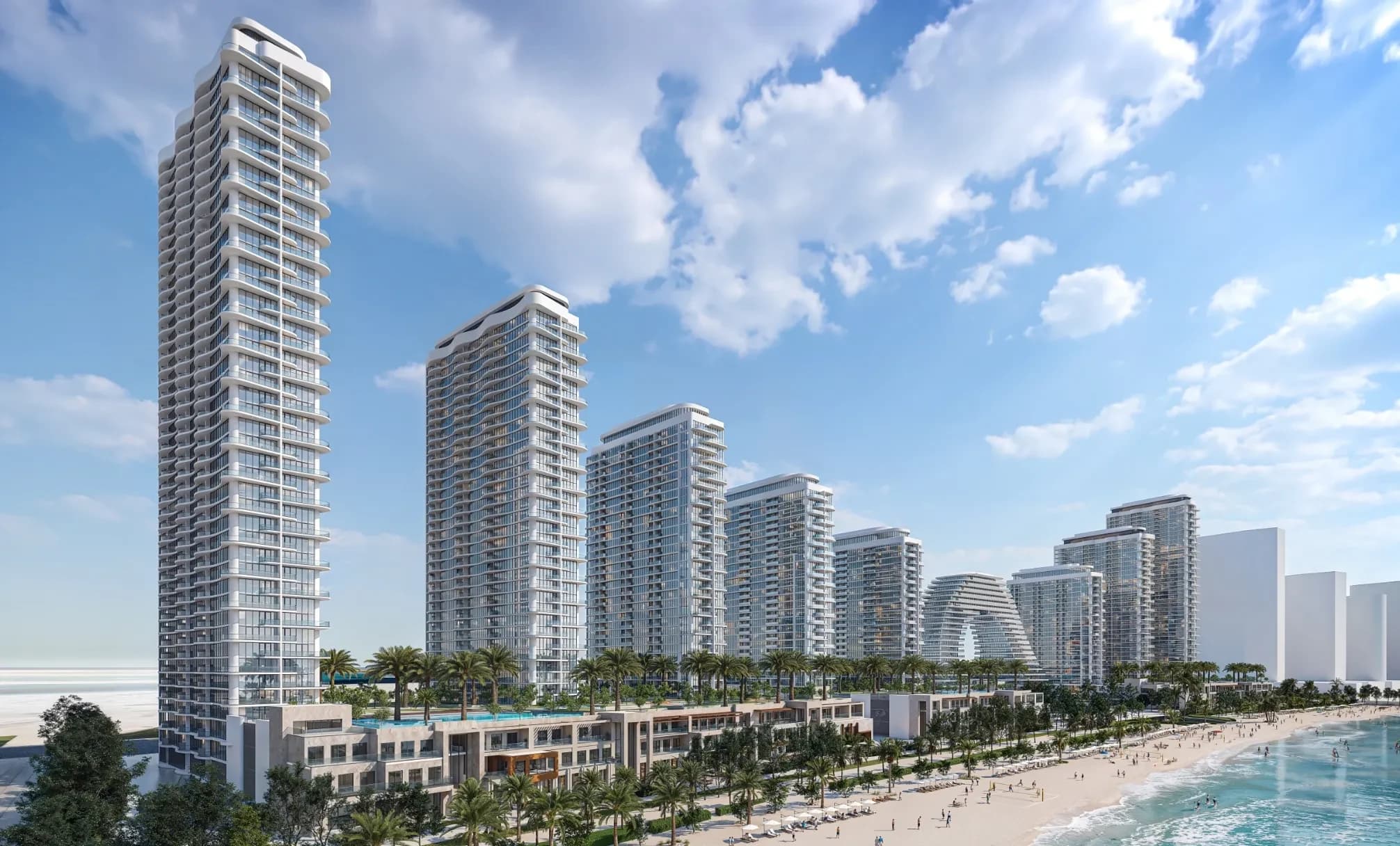 Waterfront residential towers above a landscaped promenade and beach; official developer rendering