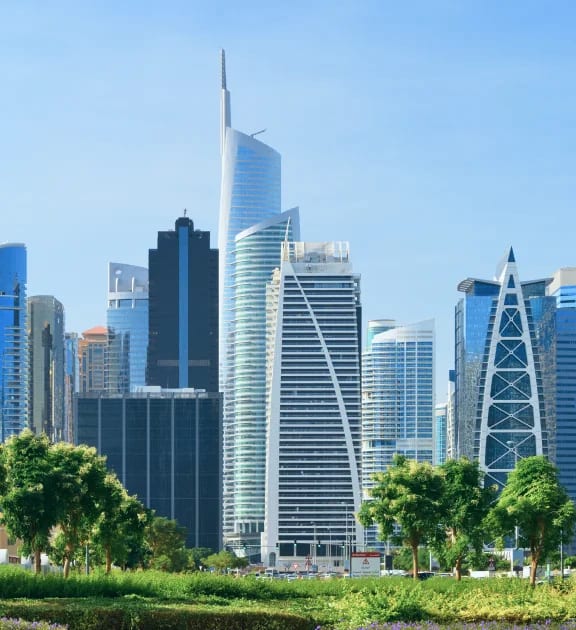 Jumeirah Lakes Towers skyline behind a landscaped foreground, official DMCC photograph. Illustrative Dubai property context.