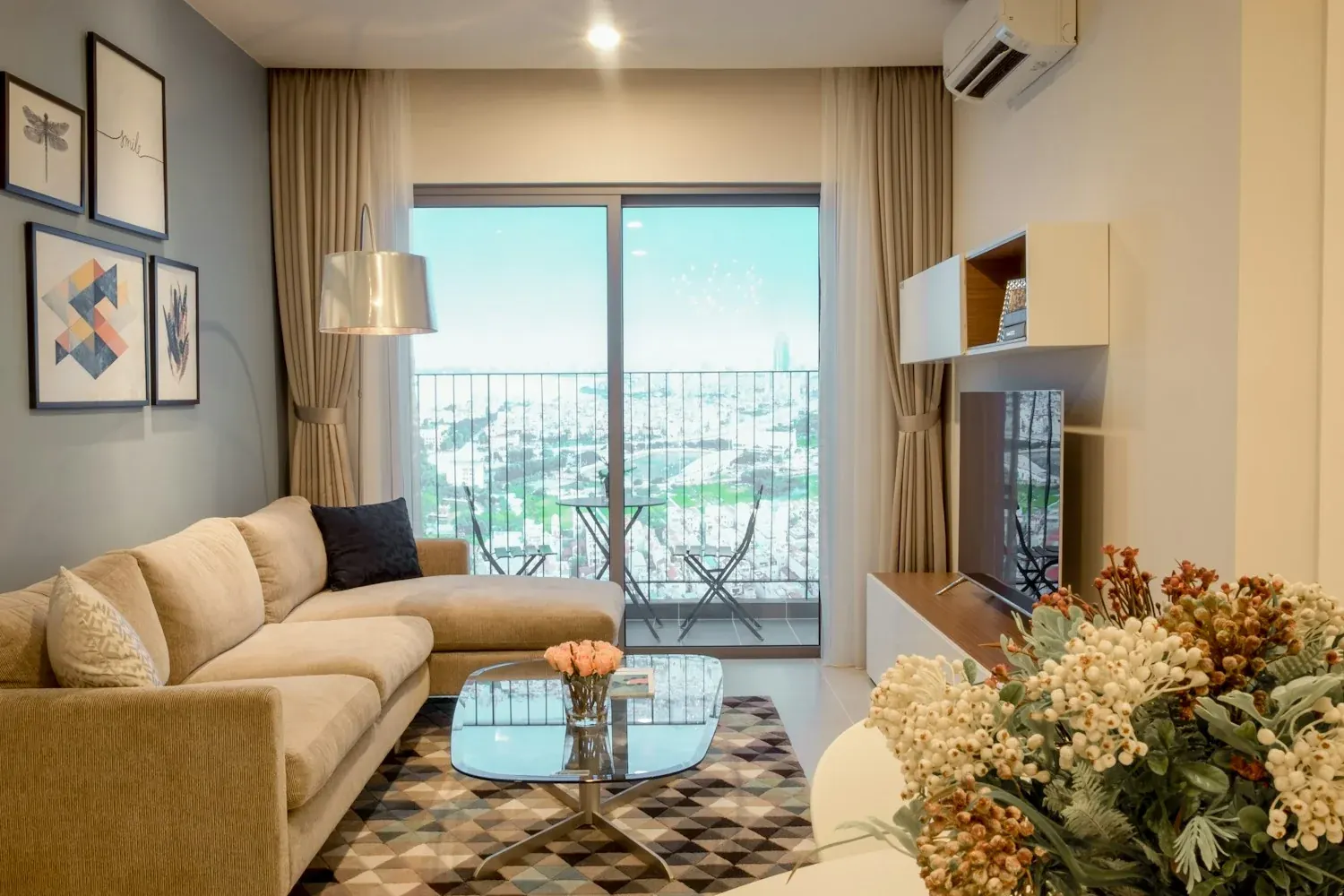 An apartment living room opening onto a balcony